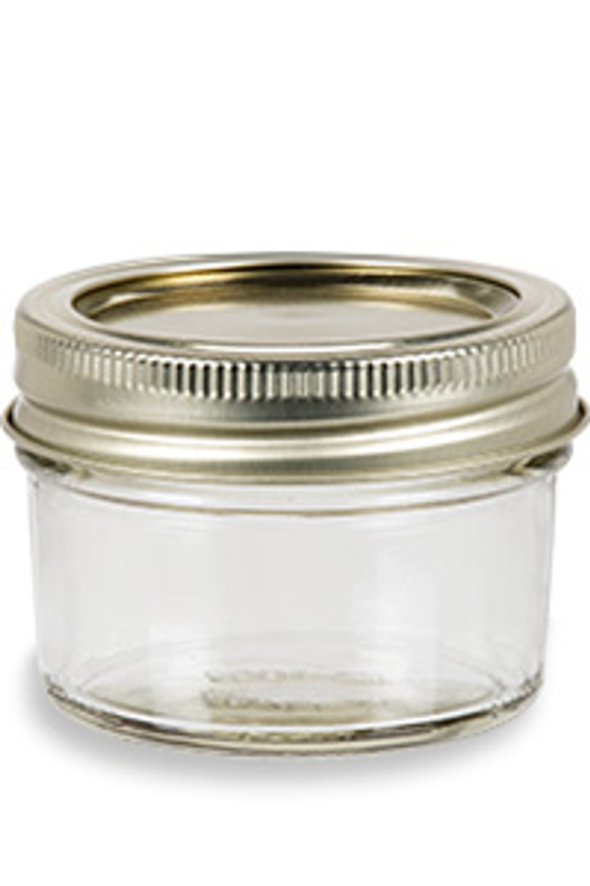 Close-up of a two-part mason jar lid showing the flat lid and the separate metal band
